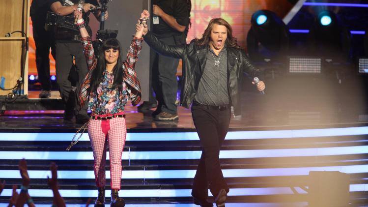 American Idol finalists Jena Irene, left, and Caleb Johnson walk on stage at the American Idol XIII finale at the Nokia Theatre at L.A. Live on Wednesday, May 21, 2014, in Los Angeles. (Photo by Paul A. Hebert/Invision/AP)