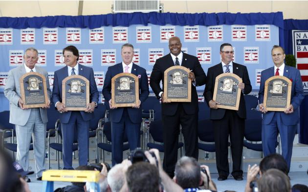 National Baseball Hall of Fame inductees, from left, Bobby Cox, Tony La Russa, Tom Glavine, Frank Thomas, Greg Maddux and Joe Torre hold their plaques after an induction ceremony at the Clark Sports C
