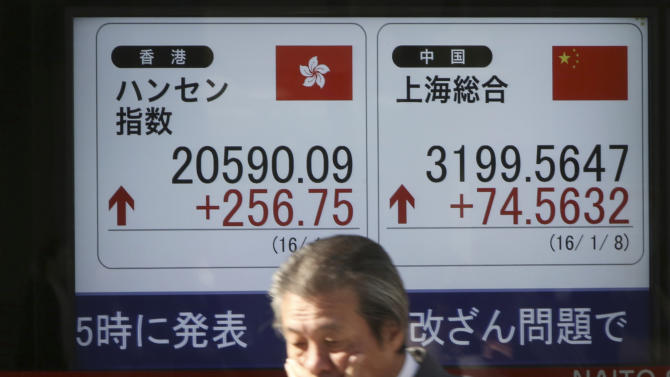 A man walks past an electronic stock board of a securities firm showing Chinese, right, and Hong Kong stock prices in Tokyo, Friday, Jan. 8, 2016. Chinese stocks were volatile Friday and other Asian markets rebounded after a plunge in Chinese prices rattled global markets. (AP Photo/Eugene Hoshiko)
