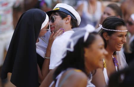 Revellers kiss each other during the annual block party known as "Carmelitas" in Rio de Janeiro