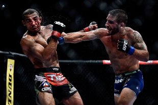 Chad Mendes (R) punches Jose Aldo in their featherweight championship bout during UFC 179. (Getty)