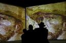 People look at the works of Van Gogh, projected on   the wall during the opening exhibition "Van Gogh. Revived paintings" in   Minsk