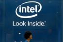 An employee walks past an Intel logo during the 2014 Computex exhibition at the TWTC Nangang exhibition hall in Taipei
