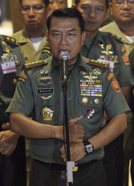 Wearing what he said to be a Chinese-made watch, Indonesian Armed Forces Chief Gen. Moeldoko speaks to the media during a press conference in Jakarta, Indonesia, Wednesday, April 23, 2014. Under fire in the media after being photographed with the luxury watch on his wrist, Indonesia's military commander says his critics should move on, explaining the timepiece is a cheap Chinese fake. (AP Photo)
