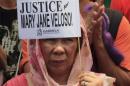 Protester holds a placard calling for justice for   Filipina drug convict Mary Jane Veloso during a protest outside the presidential   palace in Manila