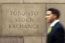 A man walks past an old Toronto Stock Exchange sign in Toronto