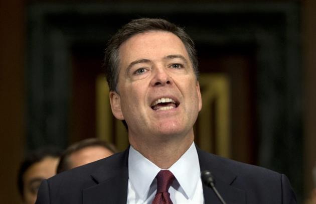 In this July 8, 2015, photo, FBI Director James Comey testifies during the Senate Judiciary Committee hearing on Capitol Hill in Washington. Comey says Dylann Roof, the gunman in the Charleston church massacre should not have been allowed to purchase the gun used in the attack, and on July 10 attributed the problem to incomplete and inaccurate paperwork related to an arrest of Roof weeks before the shooting. [AP Photo/Carolyn Kaster)