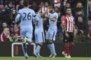 Manchester City's Gael Clichy celebrates with team-mate Sergio Aguero after scoring the third goal during their English Premier League soccer match against Southampton at St Mary's Stadium in Southampton