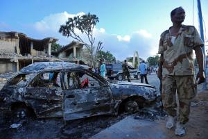 Somali soldiers and residents stand near cars and buildings &hellip;