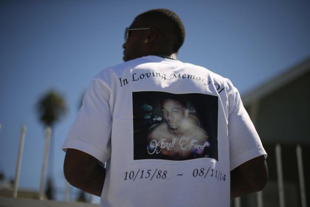 Lavell Ford wears a T-shirt protesting the fatal police shooting of his brother Ezell Ford, who died during an August 11, 2014 confrontation with police in South Los Angeles, at a rally in Los Angeles, California August 15, 2014. Police are investigating the shooting death of an unarmed black man by an officer during an "investigative stop" that led to a struggle, a police spokeswoman said on Wednesday. Police said they were not immediately identifying the deceased man, but a woman who said she was his mother told local broadcaster KTLA his name was Ezell Ford, 25. REUTERS/Lucy Nicholson (UNITED STATES - Tags: POLITICS CIVIL UNREST CRIME LAW)