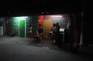 Girls wait for customers in the red light district of Angeles City, north of Manila. British banker Rurik Jutting, charged over murders in Hong Kong, was a regular in Angeles