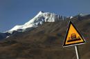 A road sign is seen in front of the Kharola glacier