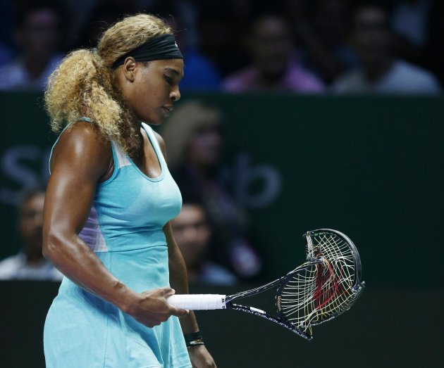 Serena Williams of the U.S. walks to her chair after smashing her racket in frustration during her semifinal match against Denmark&amp;#39;s Caroline Wozniacki at the WTA tennis finals in Singapore, Saturday, Oct. 25, 2014. (AP Photo/Mark Baker)