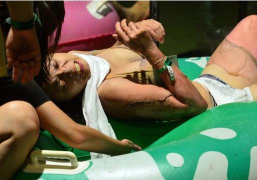 People tend to an injured woman at the Formosa Fun Coast amusement park after an explosion in the Pali district of New Taipei City on June 27, 2015