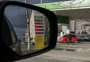 A man walks past "Amic" fuel stations in Kiev