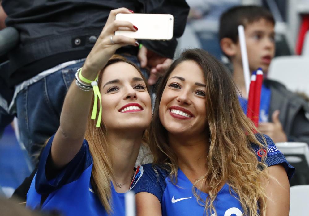 Wife of France's Morgan Schneiderlin, Camille Sold (R) in the stands