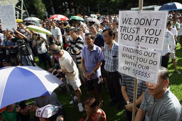 SINGAPORE - JUNE 07: People gather to listen to a speaker during the &#39;Return Our CPF&#39; protest at the Speakers&#39; Corner at Hong Lim Park on June 7, 2014 in Singapore. The protest was staged to demand greater transparency and accountability from the government on how the CPF monies are being utilized. (Photo by Suhaimi Abdullah/Getty Images)