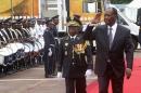 Ivory Coast's President Ouattara walks next to Chief of Staff, General Bakayoko during a parade to commemorate the country's 54th Independence Day, outside the presidential palace in Abidjan