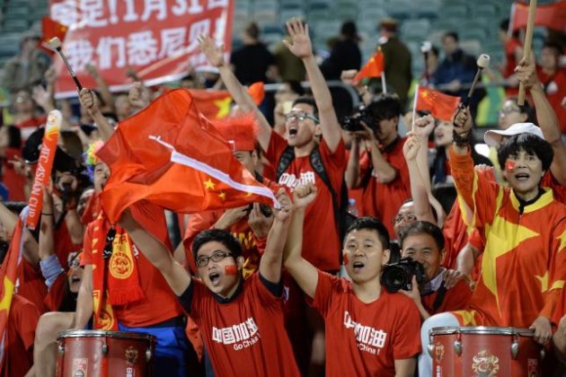 Fans of China cheer during their Group B football match against North Korea.