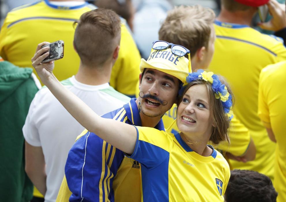 Sweden fans take a photograph before the match