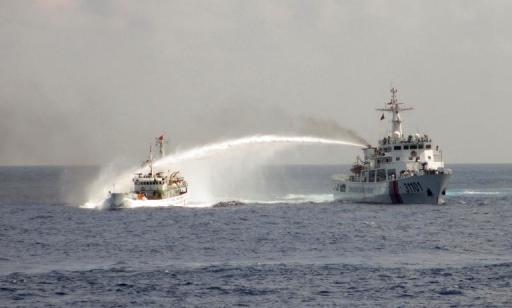 In this file photo, a China Coast Guard ship is seen using a water cannon on a Vietnamese ship in the disputed waters in the South China Sea, on May 2, 2014