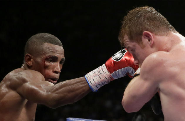 Canelo Alvarez, of Mexico, right, and Erislandy Lara, of Cuba exchange punches during their super welterweight fight, Saturday, July 12, 2014, in Las Vegas