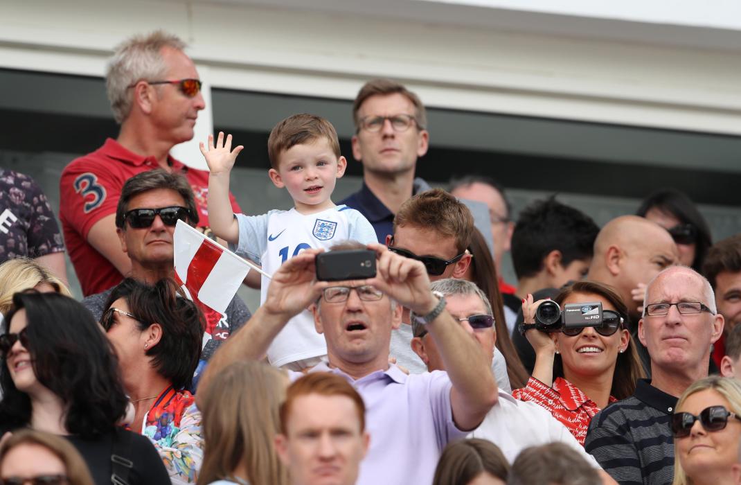 Wife of England's Wayne Rooney, Coleen with their son before the game