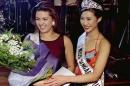 Alicia Machado of Venezuela (L), the reigning Miss   Universe, poses with the winner of the Miss Singa..