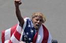 Meb Keflezighi, of San Diego, Calif., celebrates his victory in the 118th Boston Marathon Monday, April 21, 2014 in Boston. (AP Photo/Charles Krupa)
