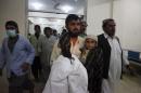 Relatives carry a boy who survived an attack on   buses, into a hospital in Quetta, Pakistan