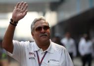 Vijay Mallya waves in the paddock during the third practice session of the Indian F1 Grand Prix at the Buddh International Circuit in Greater Noida, on the outskirts of New Delhi, October 27, 2012. REUTERS/Ahmad Masood/Files