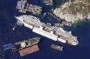 An aerial view shows the Costa Concordia as it lies on its side next to Giglio Island taken from an Italian navy helicopter