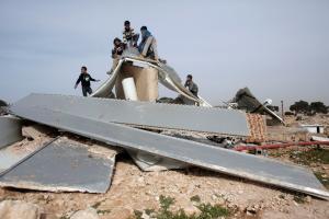 Palestinian Bedouins play around the remains of makeshift &hellip;