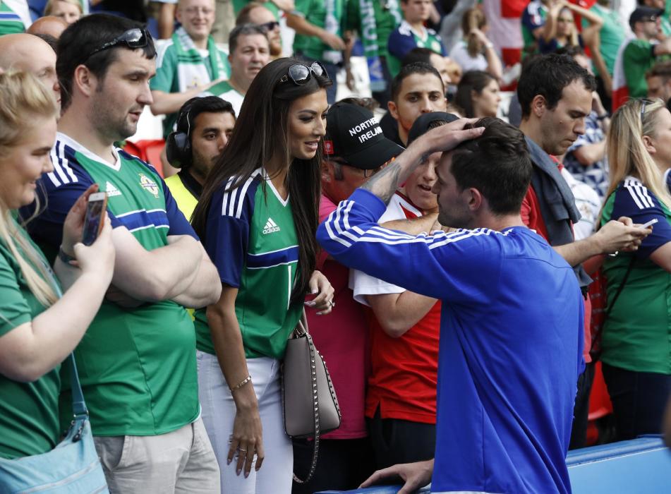 Northern Ireland's Kyle Lafferty with girlfriend Vanessa Chung after the game