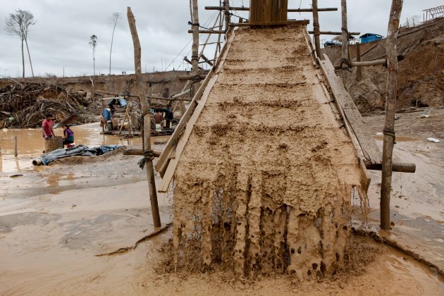 Water streams over carpets that filter the earth and water at an illegal gold mine in the La Pampa area of the Madre de Dios region in Peru, Friday, May 2, 2014. People at the illegal gold mine are working up to the last minute while they fear authorities will arrive any moment as part of a government crackdown on illegal gold mining since a nationwide ban took effect April 19. (AP Photo/Rodrigo Abd)