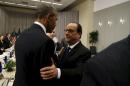 U.S. President Barack Obama greets French President   Francois Hollande during their meeting at the Nuclear Security Summit in   Washington