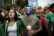 Fans of the Mexican national soccer team watch as their team battles the Netherlands in the World Cup round of 16 match on a live telecast inside the FIFA Fan Fest area during the 2014 soccer World Cup in Sao Paulo, Brazil, Sunday, June 29, 2014. The Netherlands staged a dramatic late comeback, scoring two goals in the dying minutes to beat Mexico 2-1 and advance to the World Cup quarterfinals. (AP Photo/Rodrigo Abd)