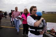 Lindsay Otters of Waverly, Ohio, waits in line with her 3-month-old daughter Emma outside of the Wright Brothers Aero Hangar for a rally by Republican presidential candidate Donald Trump Saturday, March 12, 2016, in Vandalia, Ohio. (AP Photo/Kiichiro Sato)