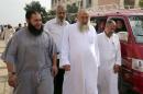 Salafist cleric leader Yasser Borhamy (C) walks with   his supporters after casting his vote at a voting centre, in Alexandria, Egypt