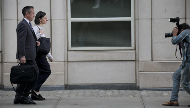 Lauren Salzman, center, leaves Brooklyn Federal Court, Thursday Oct. 4, 2018, in New York. Salzman is among defendants from the self-help group NXIVM, co-founded my her mother Nancy Salzman, charged with coercing women to be a part of a secret sub-group where they were expected to act as 