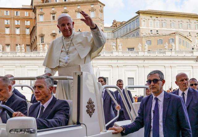 Pope Francis, flanked by newly appointed Vatican head of security Gianluca Gauzzi Broccoletti, bottom right, leaves at the end of his weekly general audience, in St.Peter's Square, at the Vatican, Wednesday, Oct. 16, 2019. (AP Photo/Andrew Medichini)