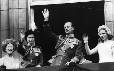 Queen Elizabeth, Prince Philip and Princess Anne wave to crowds from the balcony of Buckingham Palace after a Trooping the Colour ceremony in 1963 - Credit: Keystone