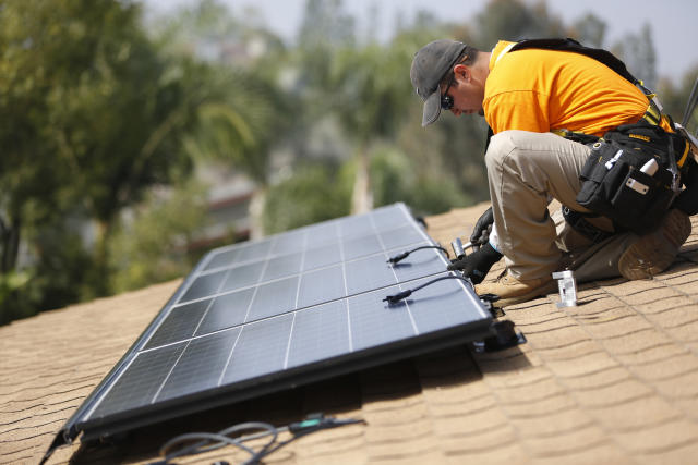 Vivint Solar technician Eduardo Aguilar installs solar panels on the roof of a house in Mission Viejo, Calif. (Photo: REUTERS/Mario Anzuoni)