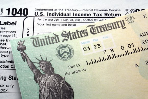 A check from the Treasury Department on top of a tax return form