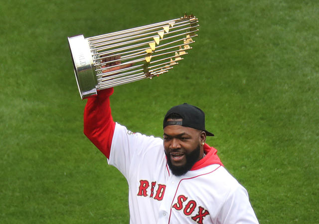 Former Boston Red Sox player David Ortiz holds up the World Series trophy during pre-game ceremonies. The Boston Red Sox host the Toronto Blue Jays in their home opener for the 2019 MLB season at Fenway Park in Boston on April 9, 2019.
