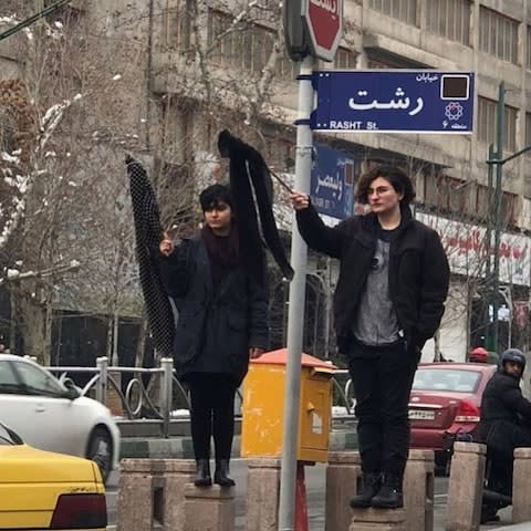 Women in Tehran stood in public waving their compulsory hijab in the form of a flag. - Credit: Facebook