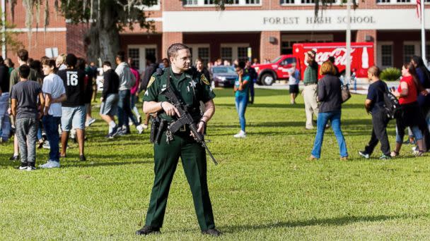 PHOTO: A Marion County Sheriff's Deputy stands outside Forest High School as students exit the school after a school shooting occurred on April 20, 2018 in Ocala, Fla. (Doug Engle /Star-Banner via AP)