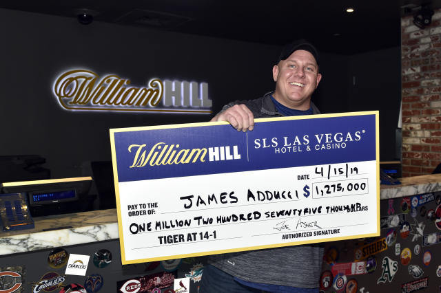 LAS VEGAS, NEVADA - APRIL 15: James Adducci of Wisconsin stands with a ceremonial check of his winnings after cashing his ticket at the William Hill Sports Book at SLS Las Vegas Hotel on April 15, 2019 in Las Vegas, Nevada. Adducci placed an USD 85,000 wager on golfer Tiger Woods to win the 2019 Masters Tournament. (Photo by David Becker/Getty Images for William Hill US)