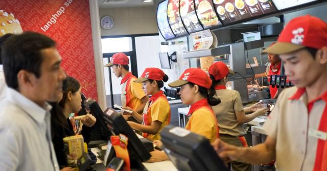 Employees serve customers inside a Jollibee Foods Corp. restaurant in Quezon City, Metro Manila, the Philippines.