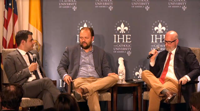 New York Times columnist Ross Douthat, center moderates debate between Ahmari and French. (Photo: Vimeo) 